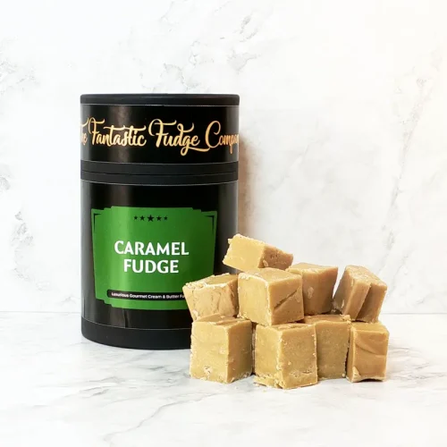 A round box of Caramel fudge with several square pieces of delicious Caramel fudge placed beside it.