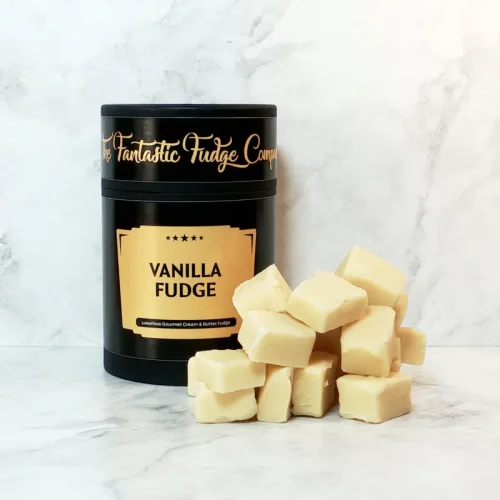 A round box of vanilla fudge with several square pieces of delicious vanilla fudge placed beside it.