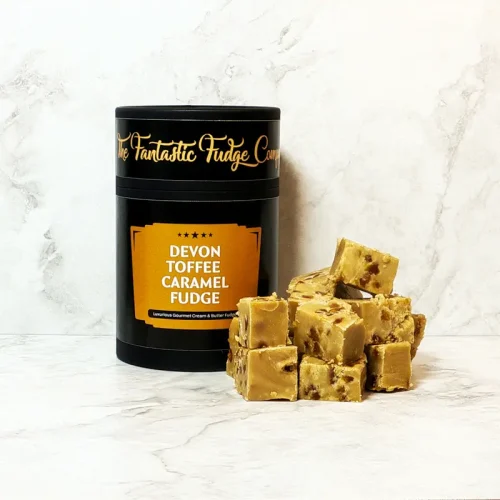A round box of Devon Toffee Caramel fudge with several square pieces of delicious Devon Toffee Caramel fudge placed beside it.