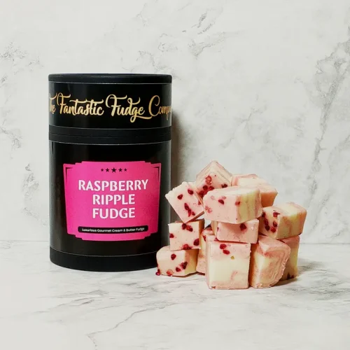 A round box of raspberry ripple fudge with several square pieces of delicious raspberry ripple fudge placed beside it.